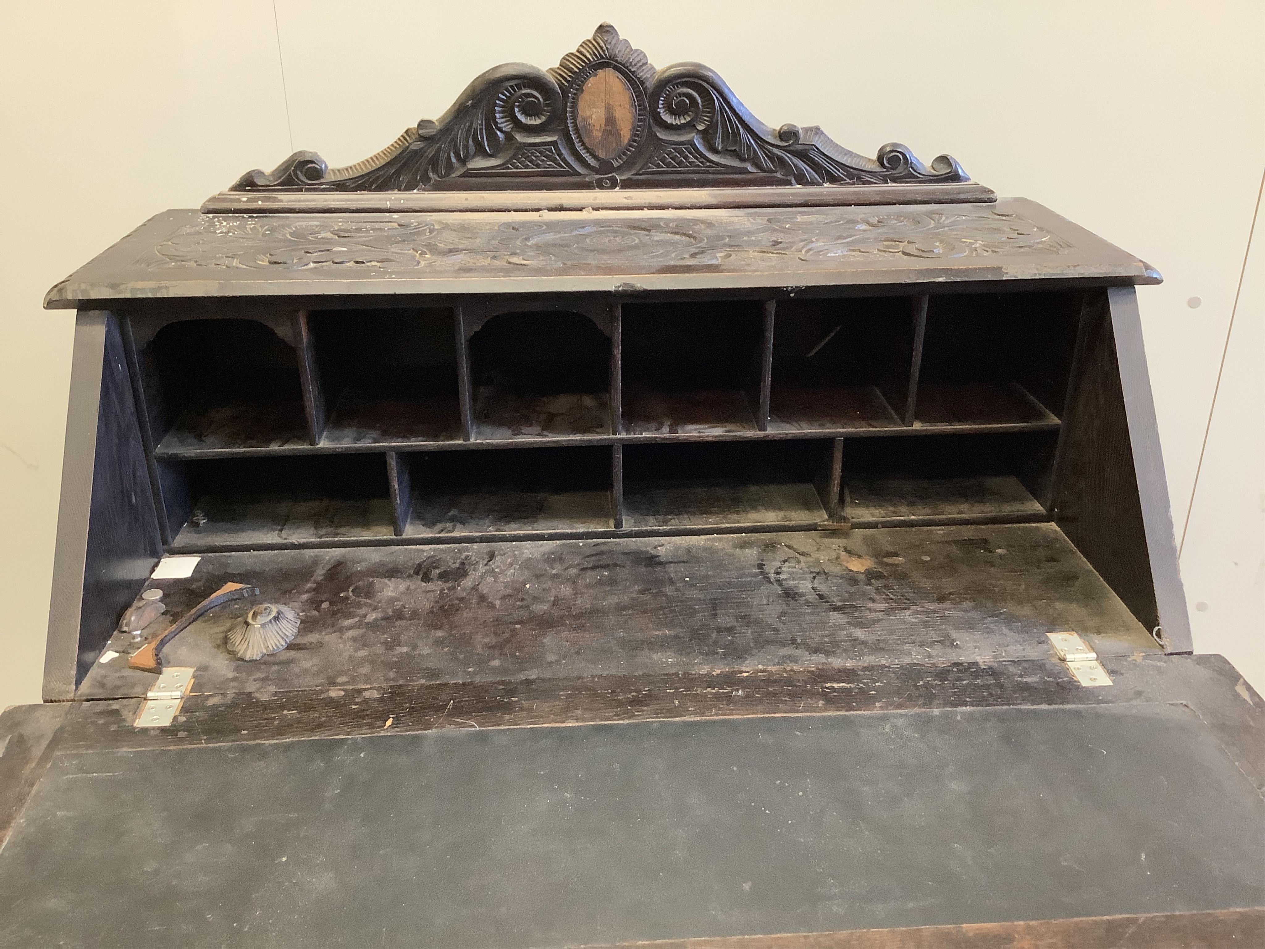 A late 19th century Flemish carved oak bureau, width 100cm, depth 49cm, height 133cm